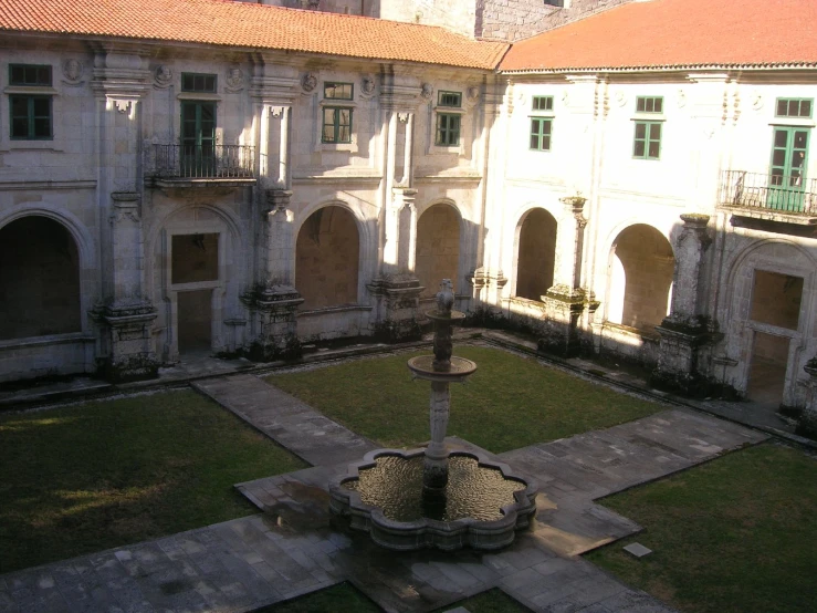 a courtyard in a large building with an elaborate fountain