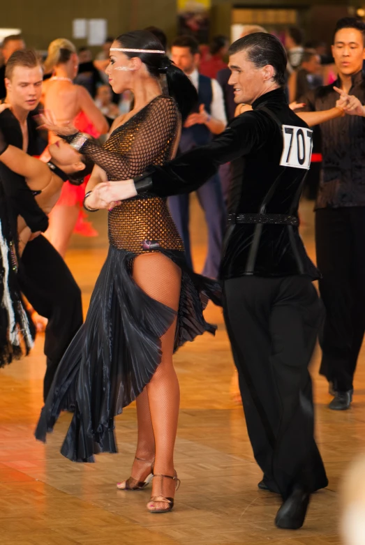 a man and woman in dance moves at a party