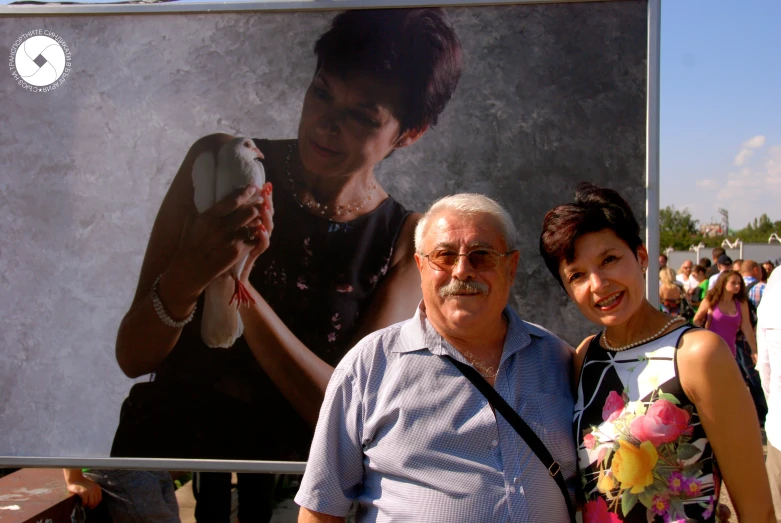 a woman standing next to a man with a camera