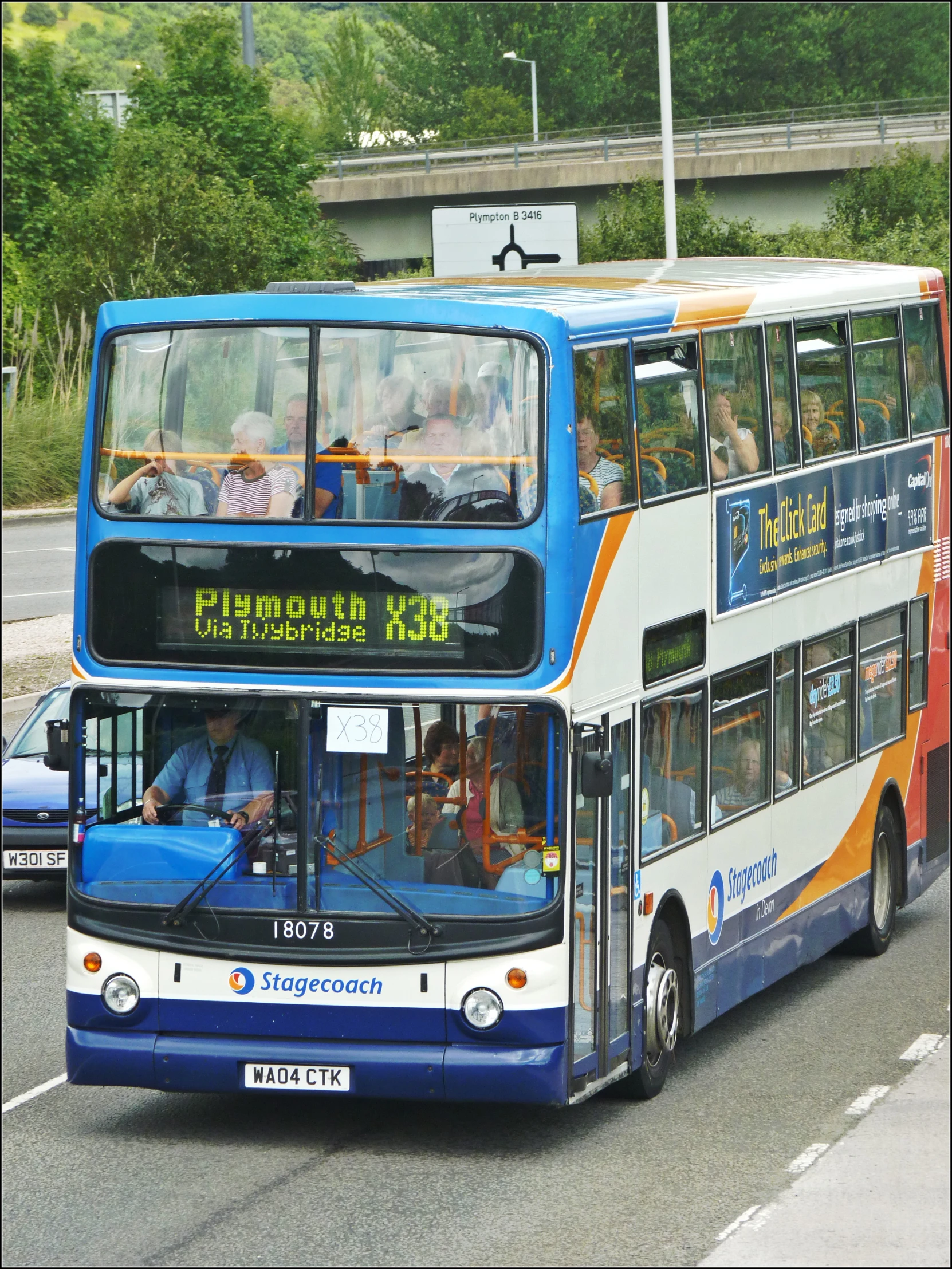 a blue and orange bus traveling down the road