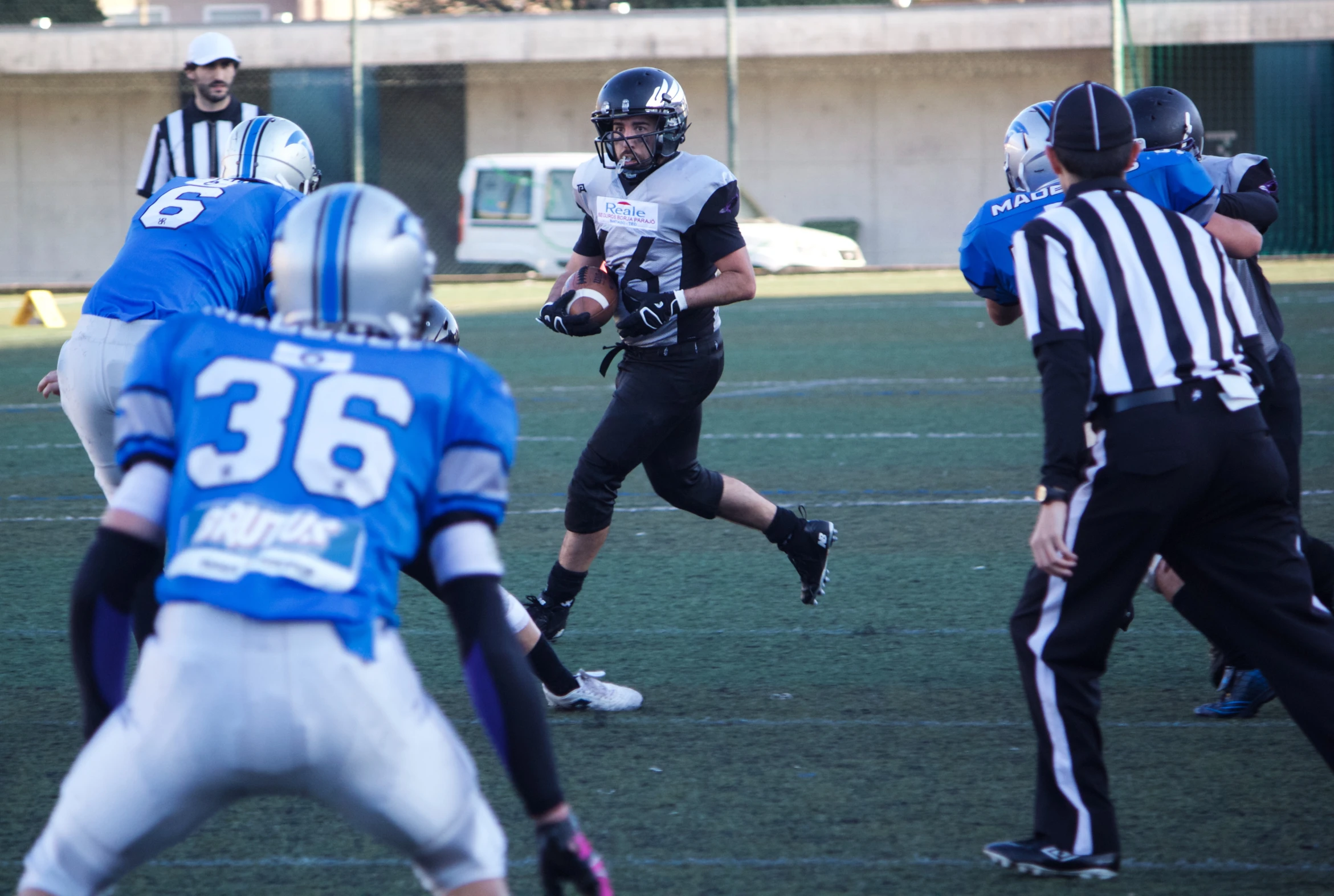 an older man running with a football during a game