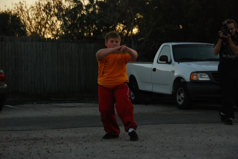 there is a man standing in the parking lot