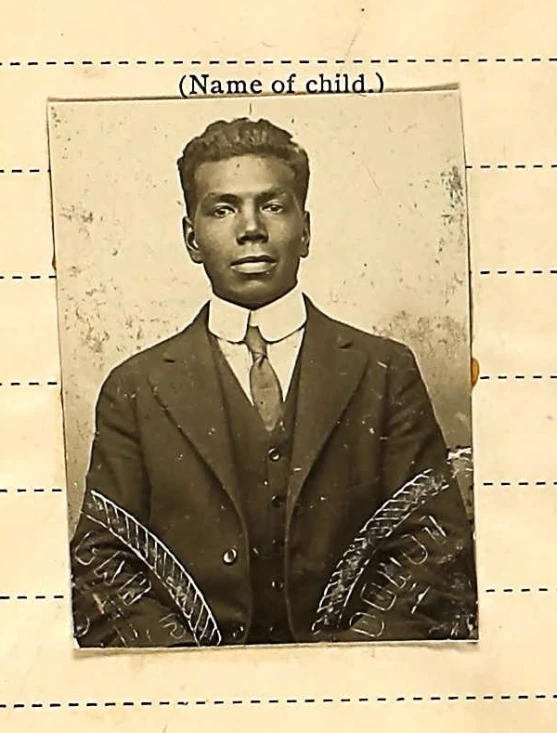 an old time picture of a young man wearing a suit