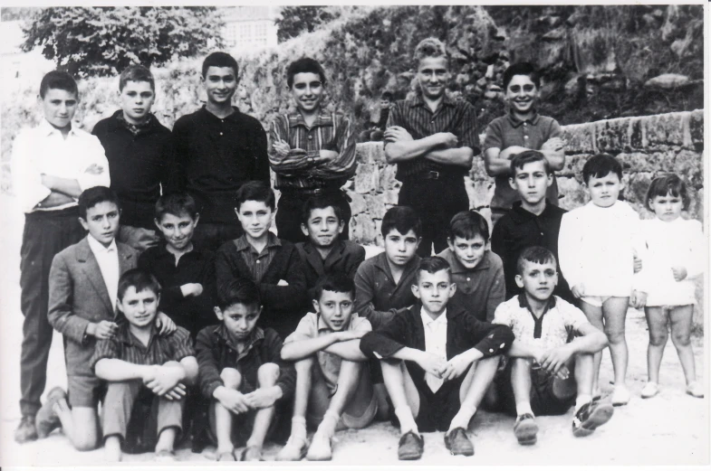 a group of boys are posing in the front row