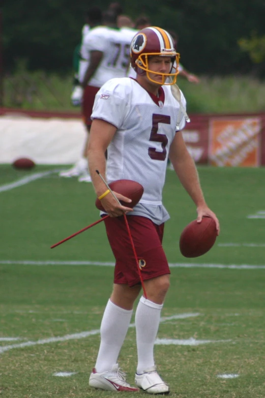 a football player holding a ball with his right hand