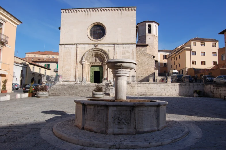 a church building with an outdoor water fountain in front of it