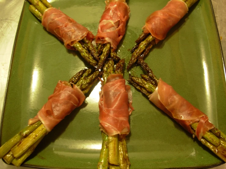 asparagus arranged in a spiral on green tray