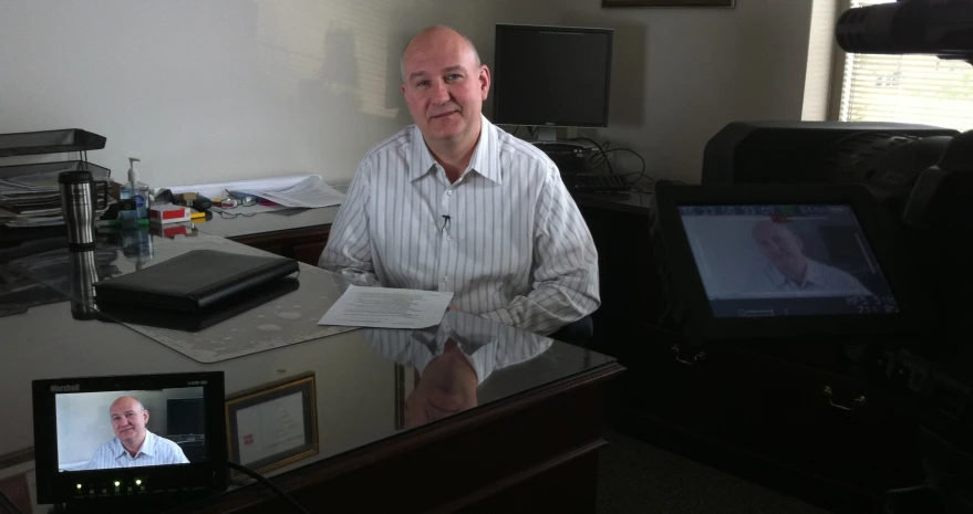 a man with bald head in office setting