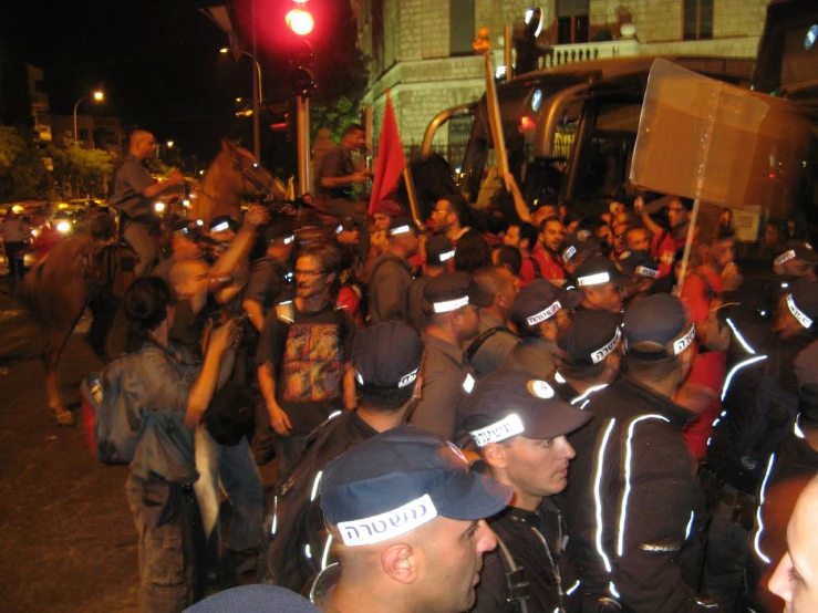 a large group of people holding up signs and standing in the street