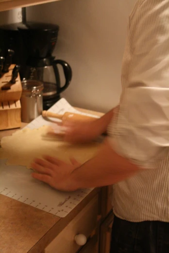man making bread in kitchen on countertop in home setting