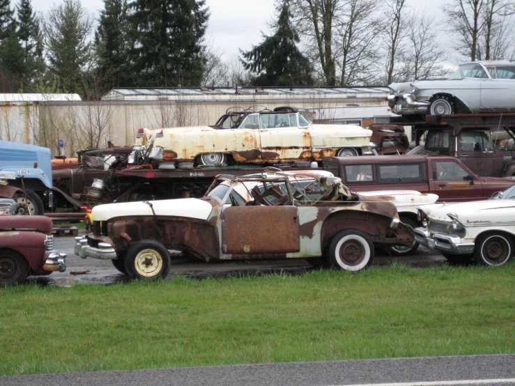 old cars and trucks are all rusted out