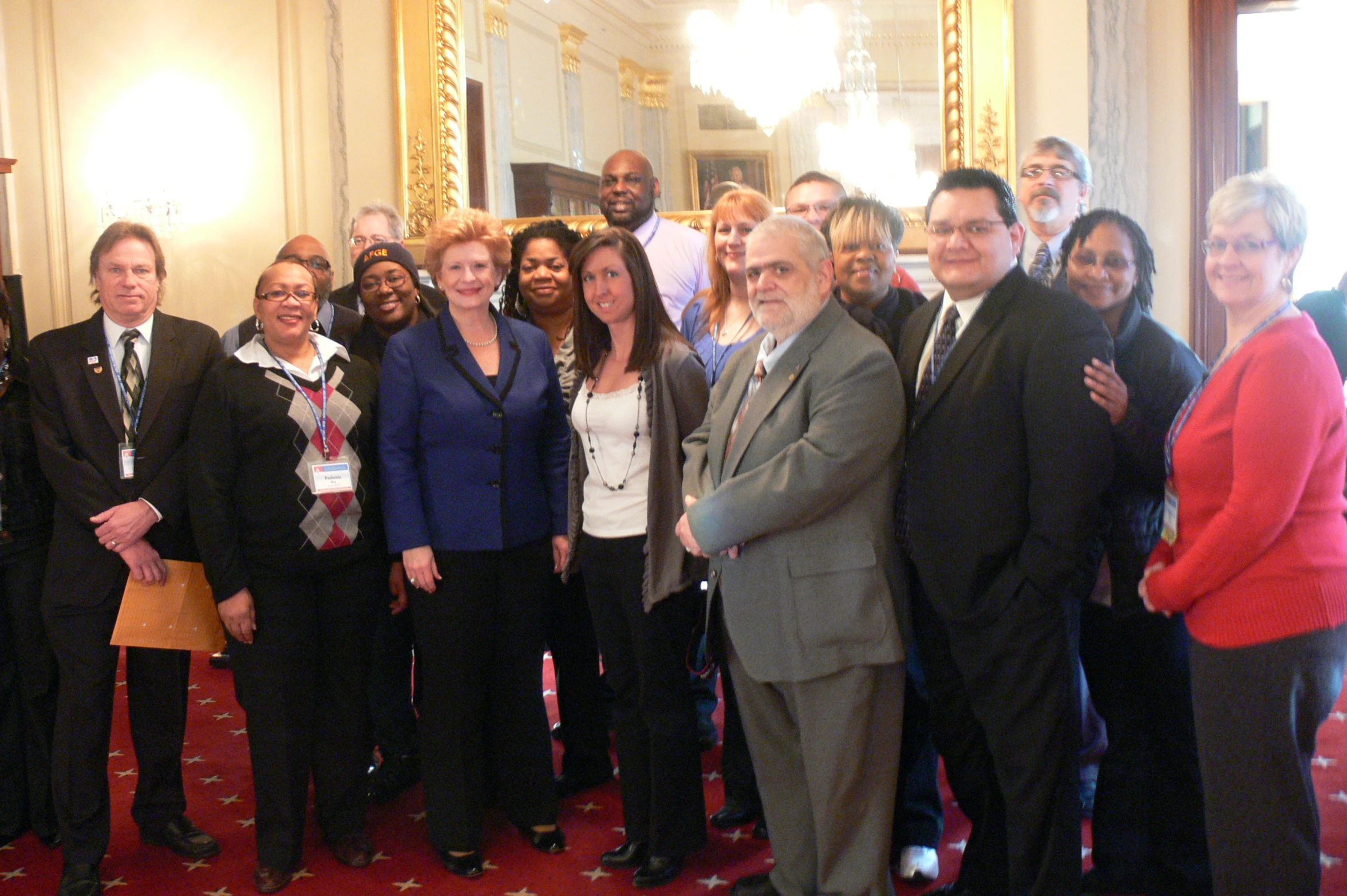 the group of people are standing and posing together