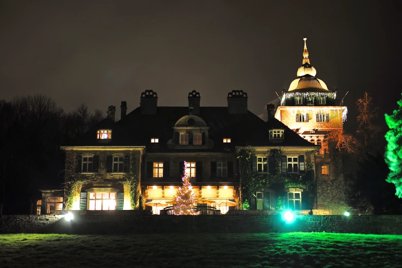 a big house that has a big tower and light up at night