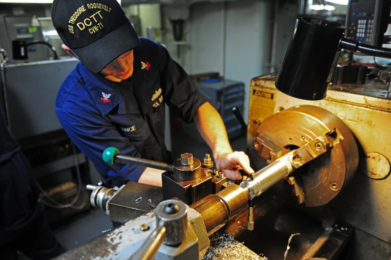 a man wearing a cap  into soing on a machine