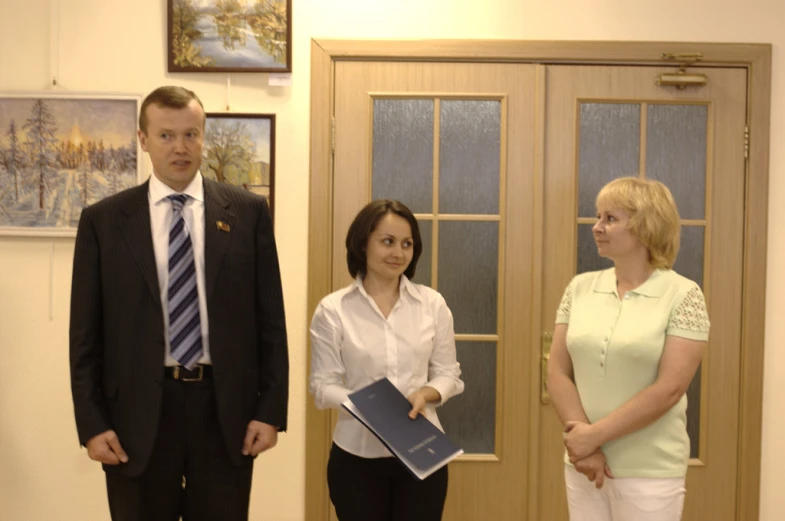 two women and a man are talking to a woman