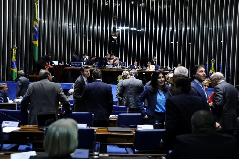 a room filled with lots of people next to a wall