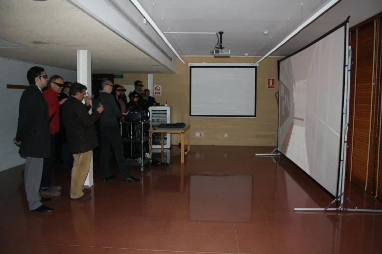 a group of people watching a man giving a presentation