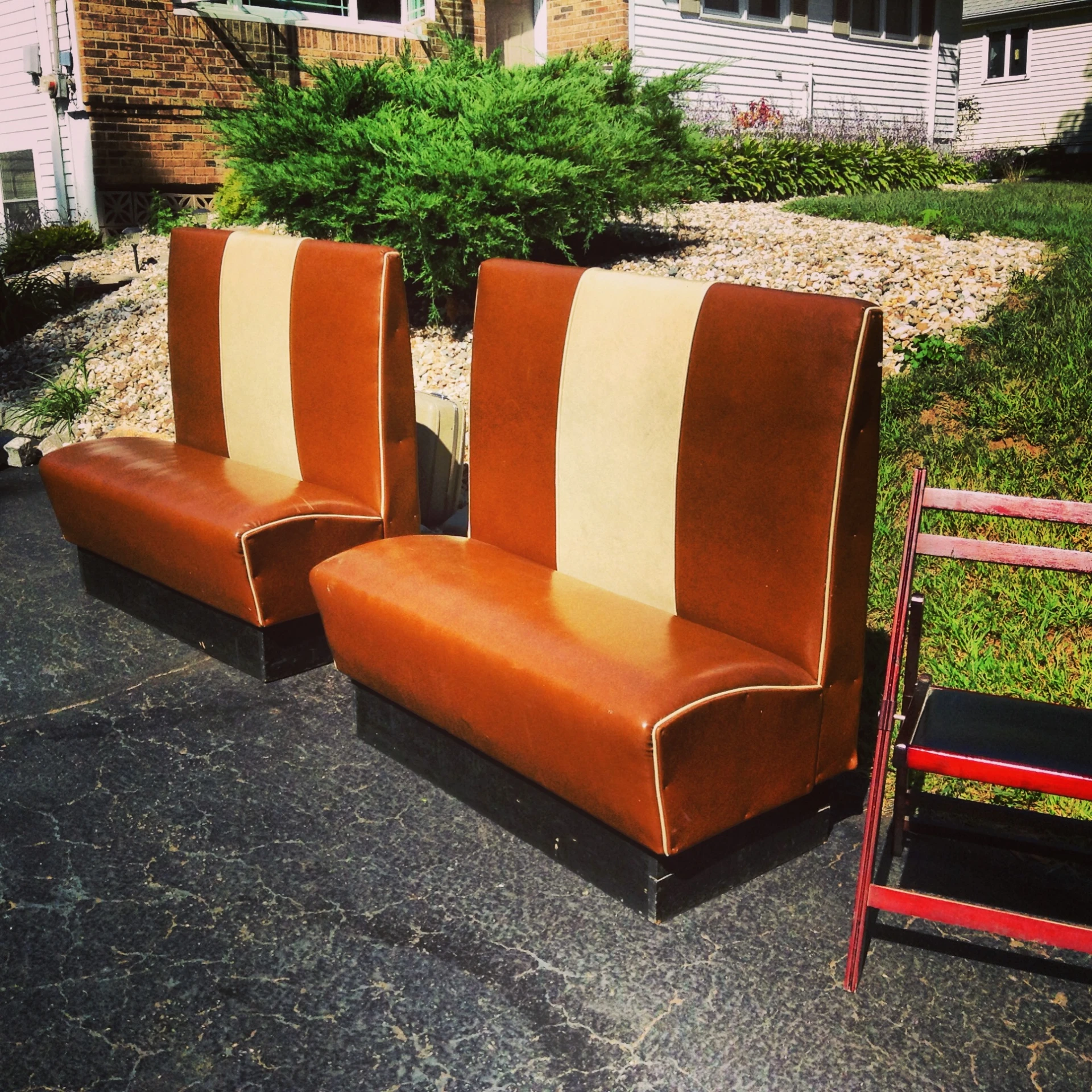 two modern style couches with red and orange cushions