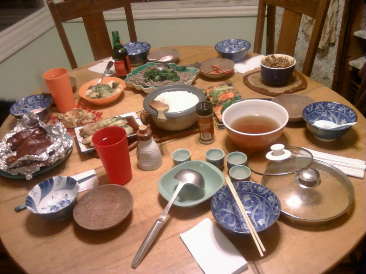 a table covered in tea and cups with bowls