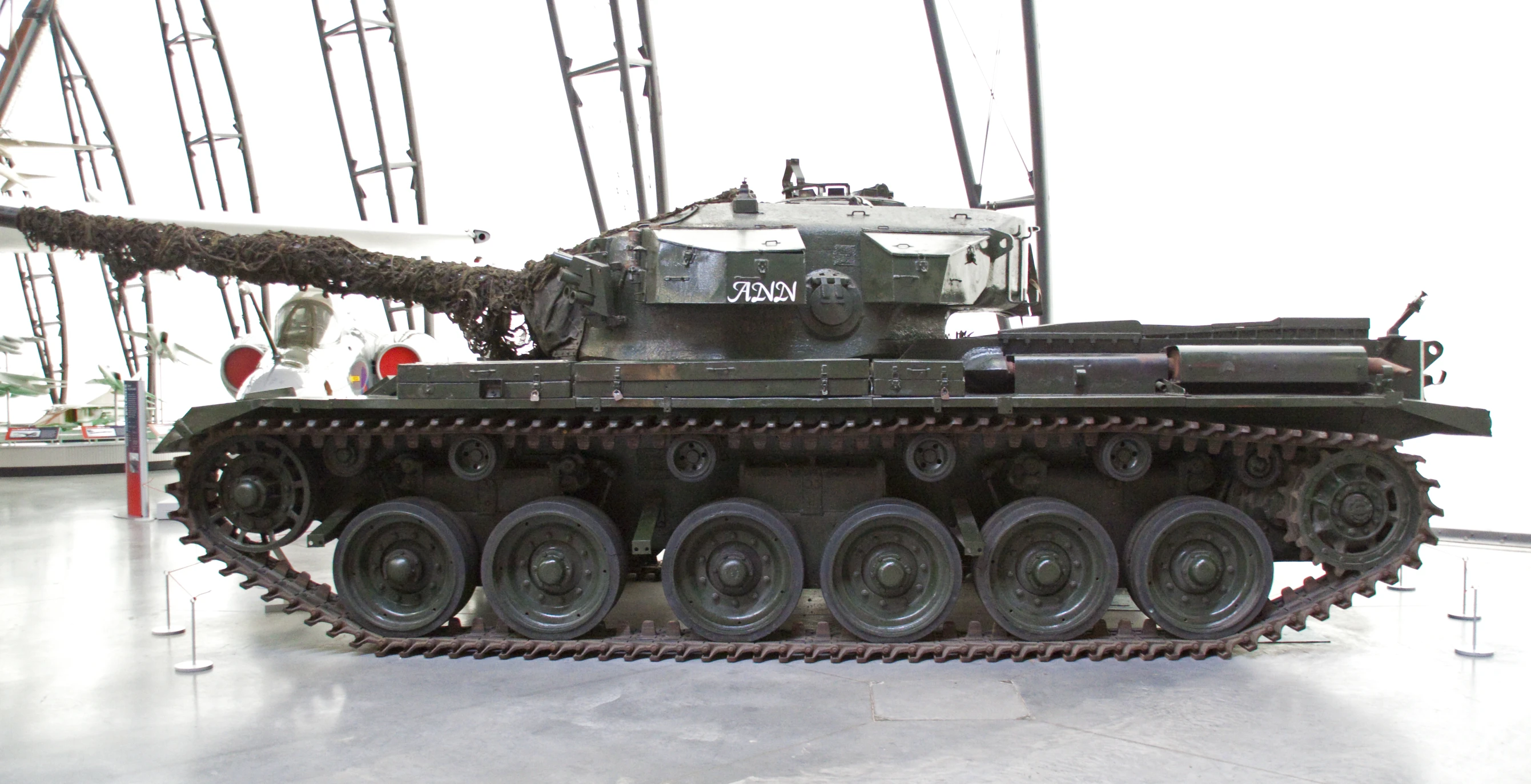 a museum displays an antique army vehicle in the foreground