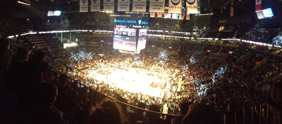 a basketball game in a large arena during the night