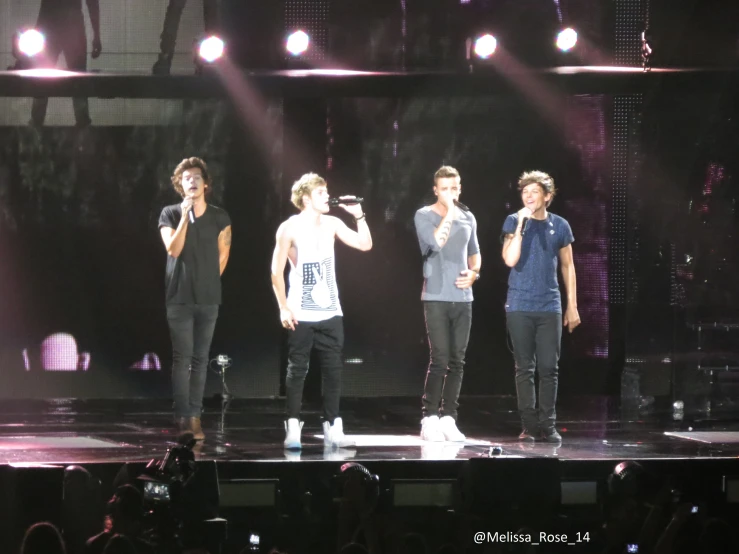 one direction perform onstage at an american music awards