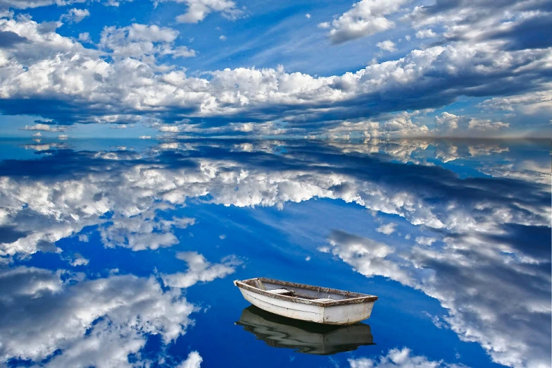 a boat floating in the middle of the ocean