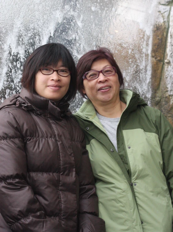 an older woman and younger woman pose for a po