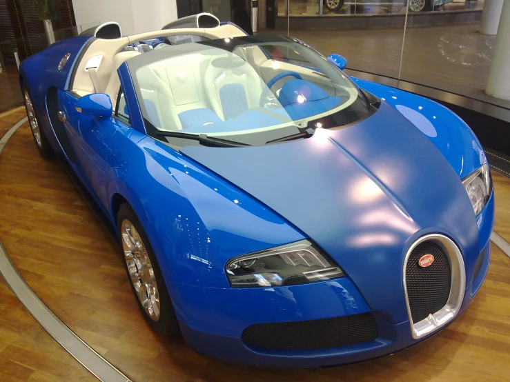 a blue sports car parked inside of a building