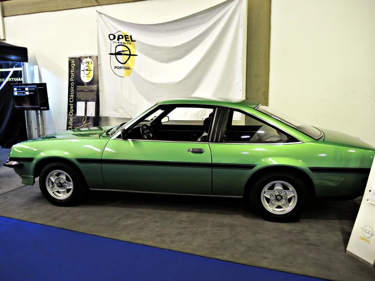 a green car is on display for people to see