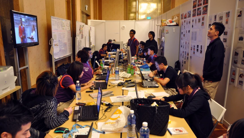 people are gathered at a conference room table