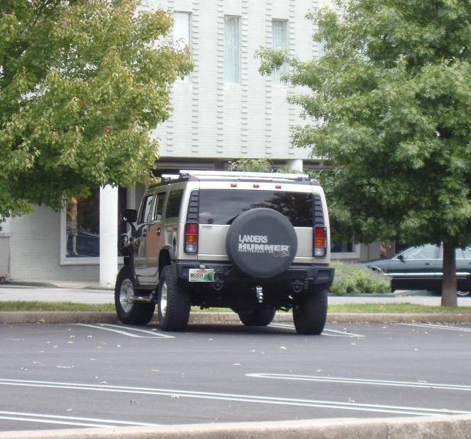 an suv with a black tire cover sits parked