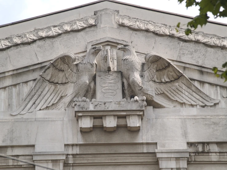 a large eagle sits atop an old building