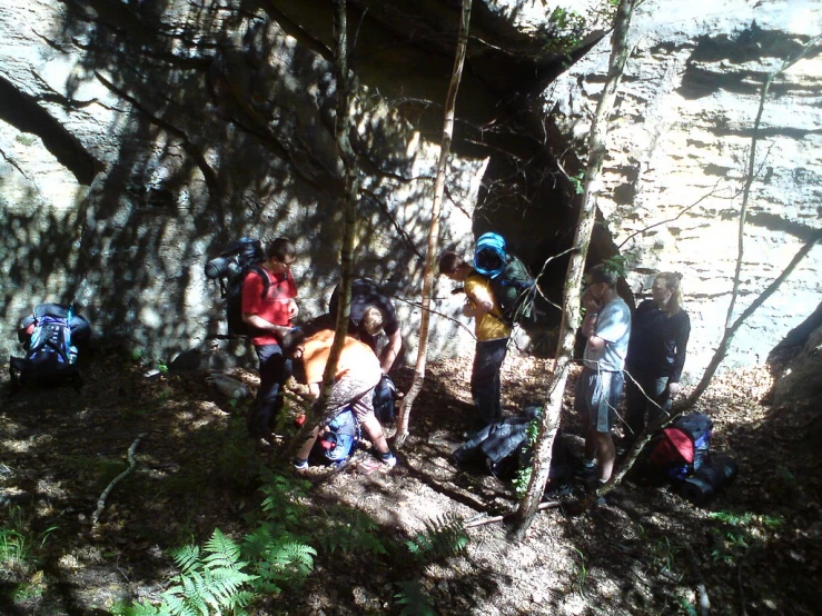 the four people are climbing up the mountain