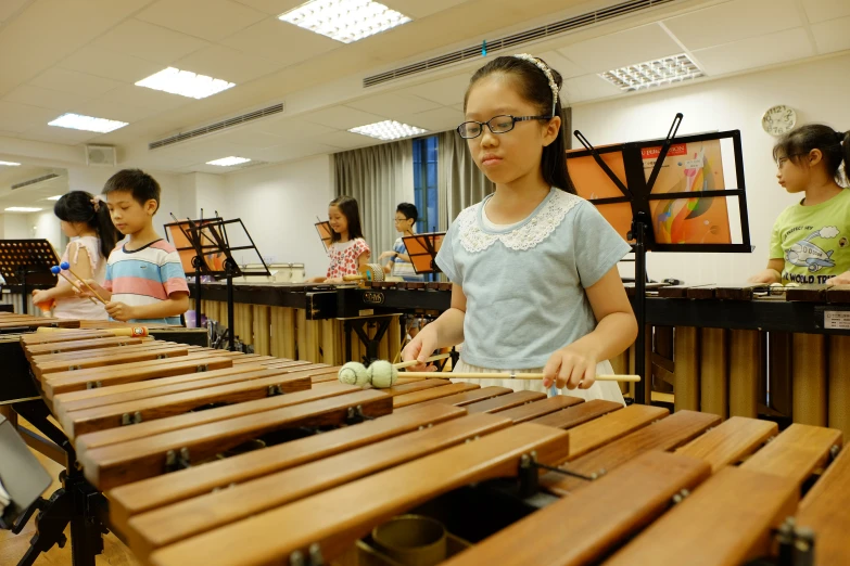 children play a musical instrument game at a music classroom