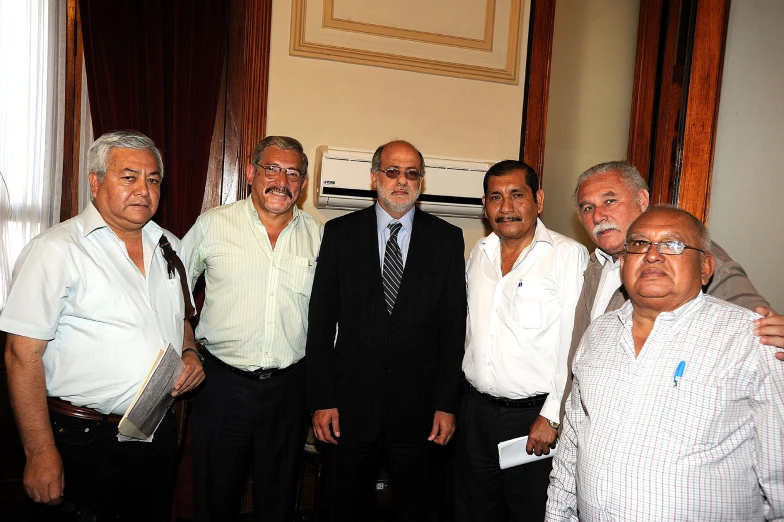 a group of men are dressed in suits and ties