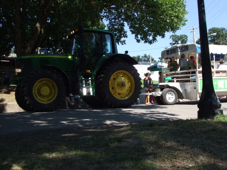 a large tractor sitting next to a bus