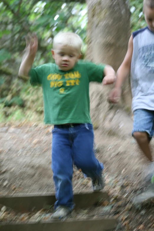 two small children in a park are holding hands