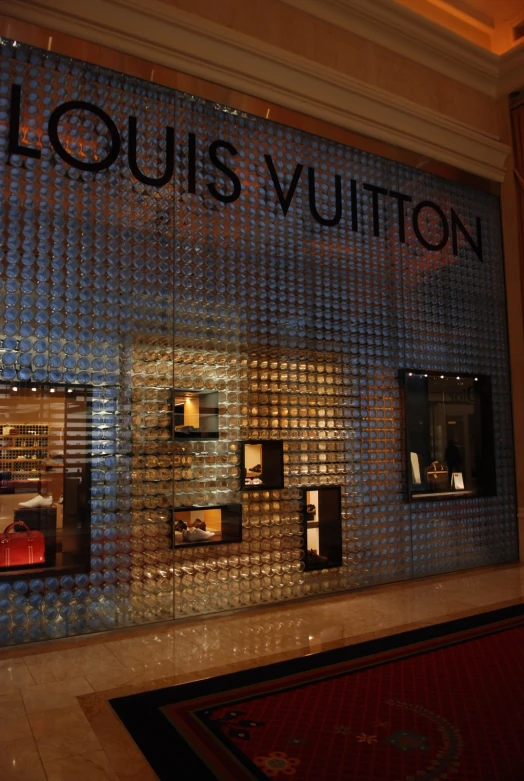 a room containing a display of louis vuitton shoes