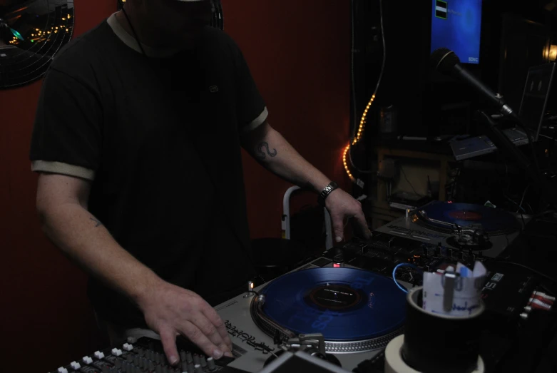 dj playing an audio disc disc in front of a computer