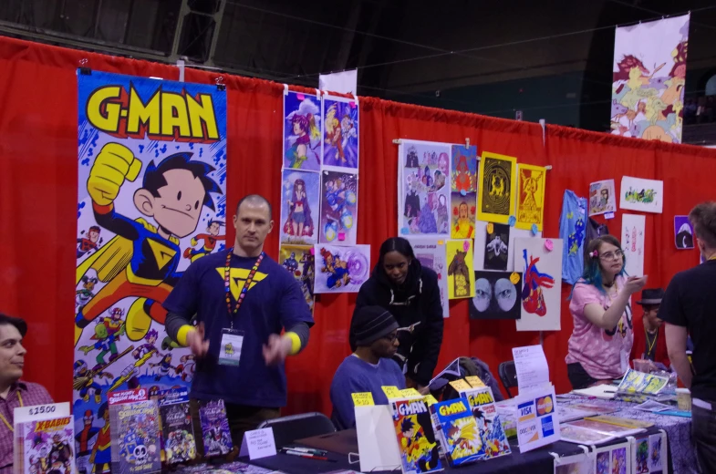 a man standing next to a woman at a booth