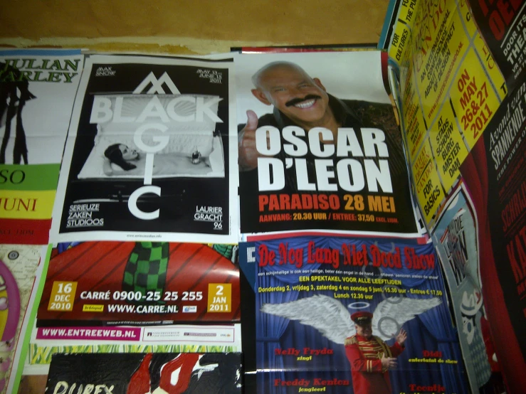 a wall of posters and flyers in spanish language
