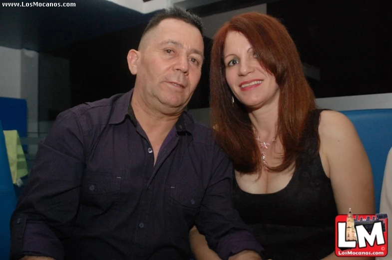 man and woman with red hair posing together