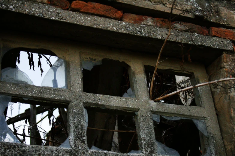 a bunch of broken windows inside a building