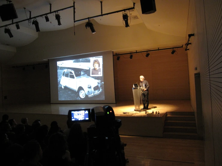 a person is speaking in front of an audience