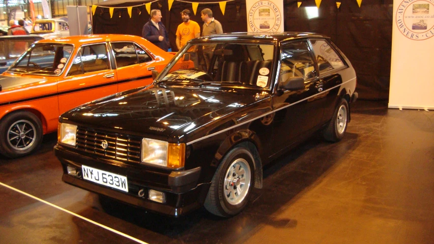 a group of cars on display at an automobile museum