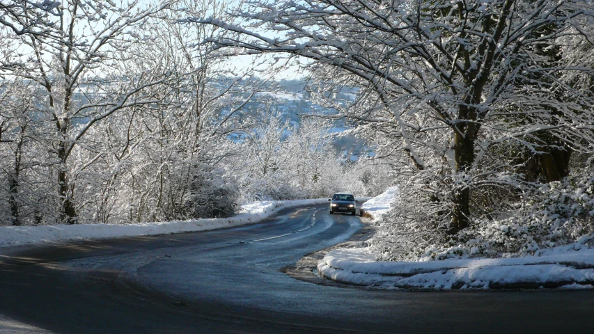 the truck is driving down the snowy road