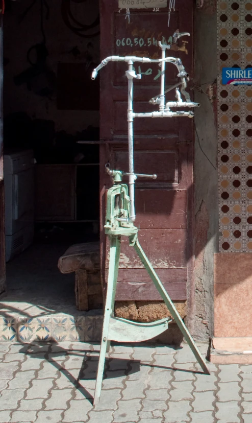 a very old water pump outside a building