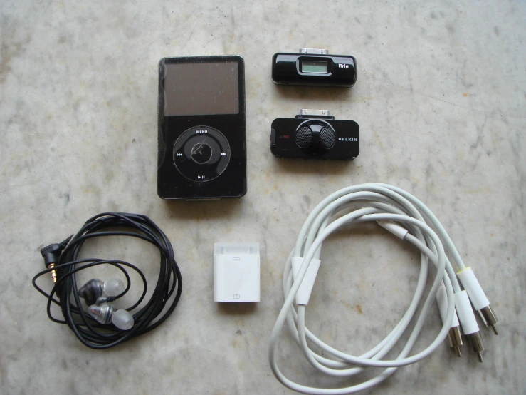 a table topped with electronic devices and cable