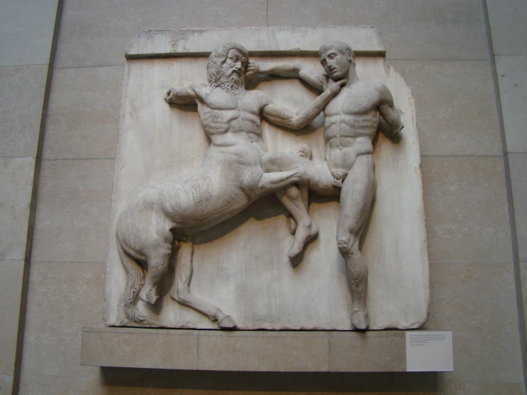 the statue depicts two men fighting in an ancient style